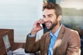 Happy man, technology and phone call in coffee shop for talk, online working, and networking. Laptop, male person and Royalty Free Stock Photo