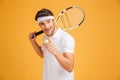 Happy man tennis player holding racket and pointing on you Royalty Free Stock Photo