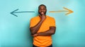 Joyful and happy man thinks which arrow to follow