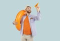 Happy man tossing paper airplane, holding inflatable rubber ring, tourist dreaming of flight Royalty Free Stock Photo