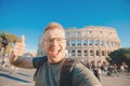 Happy man tourist with backpack with glasses taking selfie photo Colosseum in Rome, Italy Royalty Free Stock Photo