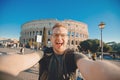 Happy man tourist with backpack with glasses taking selfie photo Colosseum in Rome, Italy Royalty Free Stock Photo