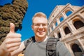 Happy man tourist with backpack with glasses taking selfie photo Colosseum in Rome, Italy Royalty Free Stock Photo