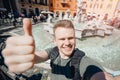 Happy man tourist taking selfie photo on background fountain Four rivers in Piazza Navona, Rome Italy Royalty Free Stock Photo