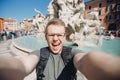Happy man tourist taking selfie photo on background fountain Four rivers in Piazza Navona, Rome Italy Royalty Free Stock Photo