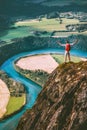 Happy Man traveler standing on cliff mountain hands raised Royalty Free Stock Photo