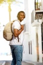 Happy man traveling with bag and headphones Royalty Free Stock Photo