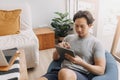 Happy man use tablet for work on bean bag in the living room of the house. Royalty Free Stock Photo