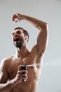 Happy man using deodorant Royalty Free Stock Photo