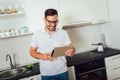 Man using digital tablet in kitchen at home Royalty Free Stock Photo