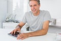 Happy man using digital tablet in kitchen Royalty Free Stock Photo