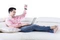 Happy man using laptop on couch Royalty Free Stock Photo