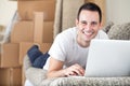 Happy man using laptop in his new home Royalty Free Stock Photo