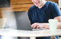 Happy man using laptop home or cafe. Royalty Free Stock Photo