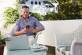 Happy man using mobile phone while sitting at cafe Royalty Free Stock Photo