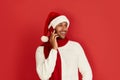 Happy Man Using Smartphone. Multiracial Guy Santa Hat Smiling Calling Cellphone