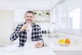 Happy man using a tablet after breakfast in kitchen Royalty Free Stock Photo