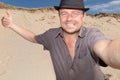 Happy man on vacation on beach take selfie Royalty Free Stock Photo