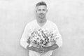 happy man with valentine flowers. man with valentine flowers in studio.