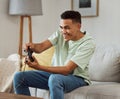 Happy man, video games and playing on sofa with controller in living room for fun online match at home. Young male Royalty Free Stock Photo