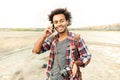 Happy man with vintage photo camera talking on mobile phone Royalty Free Stock Photo