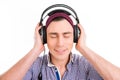 Happy man in violet cap listening music with closed eyes