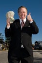 Happy man with wad of cash. Royalty Free Stock Photo