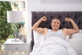 Happy man waking up after sleeping on comfortable pillow Royalty Free Stock Photo