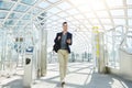 Happy man walking by automated turnstile with phone Royalty Free Stock Photo