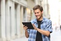 Happy man walking browsing tablet online content Royalty Free Stock Photo