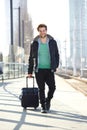 Happy man walking on train station platform with bag Royalty Free Stock Photo