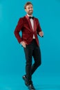 Happy man wearing red velvet tuxedo and walking Royalty Free Stock Photo