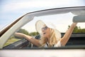 Happy man and woman driving in cabriolet car Royalty Free Stock Photo