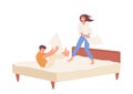 Happy man and woman fighting pillows on bed, playful family couple having fun together at home Royalty Free Stock Photo