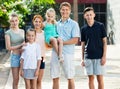 Man and woman with four kids smiling and taking walk