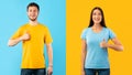Happy man and woman gesturing thumbs up and smiling Royalty Free Stock Photo