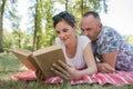 Happy man and woman with laptop on grass Royalty Free Stock Photo