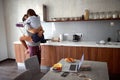 Happy man and woman in the morning kissing at kitchen. Love, Romance and valentineÃ¢â¬â¢s day concept