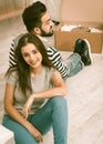 Happy man and woman sitting on the floor tired preparing to relocate to new apartment Royalty Free Stock Photo