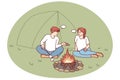 Man and woman relaxing near campfire