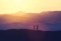 Happy man and woman standing on a hill