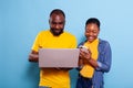 Happy man and woman using laptop computer and smartphone Royalty Free Stock Photo