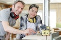 happy man and woman in wood workshop Royalty Free Stock Photo