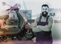 Happy man worker displaying his workplace in motorcycle workshop Royalty Free Stock Photo