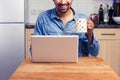 Happy man working on his laptop at home Royalty Free Stock Photo