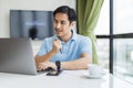 Happy man working online with laptop computer at home sitting at desk. Royalty Free Stock Photo