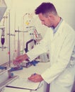 Happy man working on quality of products in lab