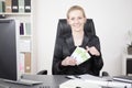 Happy Manageress at her Desk Holding a Fan of Cash