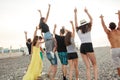 Happy mans and womans walk at the beach Group of friends enjoying beach holidays