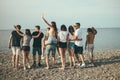 Happy mans and womans walk at the beach Group of friends enjoying beach holidays